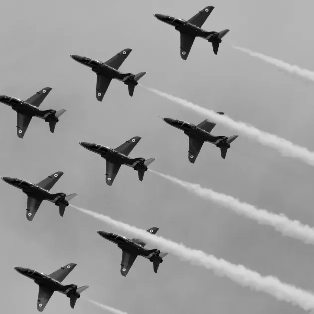 The Red Arrows using white smoke in the sky.
