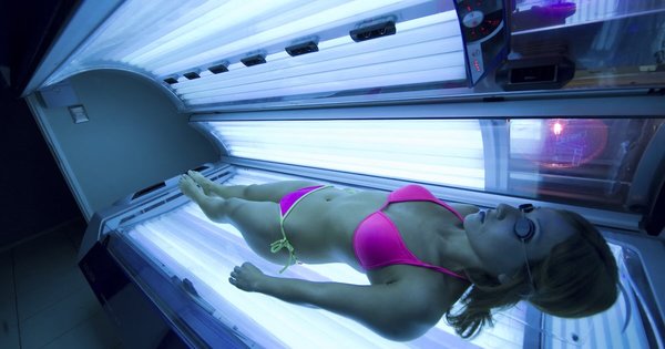 A woman lies on a sunbed