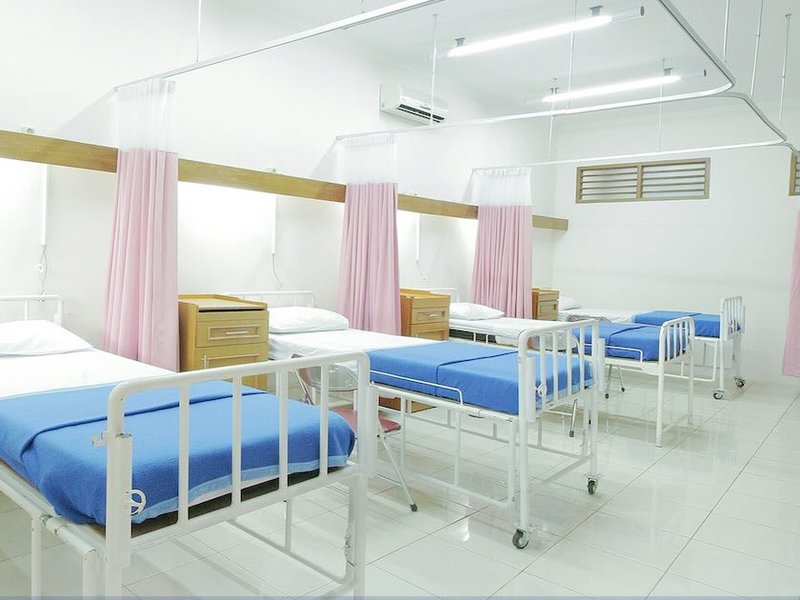 Empty hospital beds in a ward