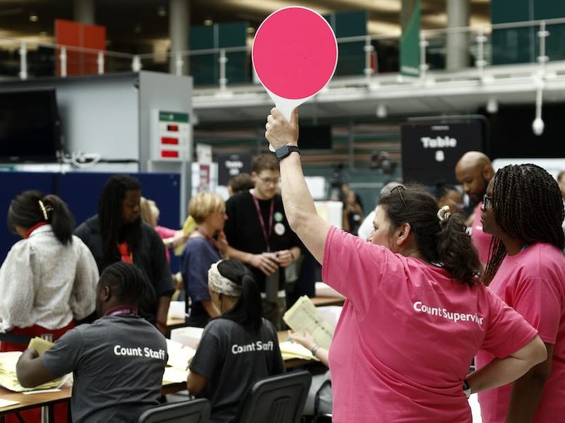 Staff count ballots the morning after local elections at a vote-counting centre inside the count centre for Hackney, north London on 8 May.