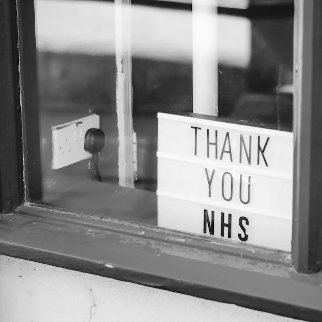 a card in a window saying “thank you nhs”