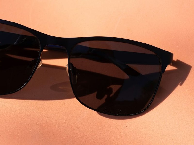 Dark sunglasses on an orange background