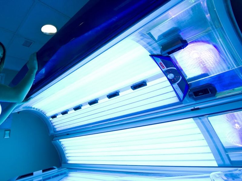 A woman opens a sunbed