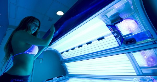 A woman opens a sunbed