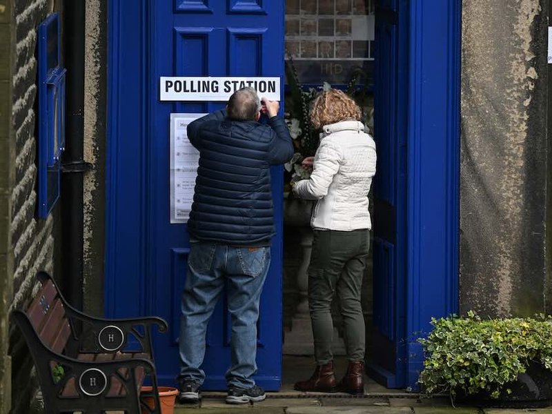 A Polling Station sign is put up at Holy Trinity Church being used as a polling station in Dobcross in northern England during local elections on May 5, 2022.
