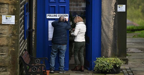 A Polling Station sign is put up at Holy Trinity Church being used as a polling station in Dobcross in northern England during local elections on May 5, 2022.