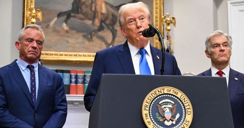 US President Donald Trump (C), alongside Secretary of Health and Human Services Robert F. Kennedy Jr. (L) and Medicare and Medicaid Administrator Mehmet Oz (R), speaks about autism in White House