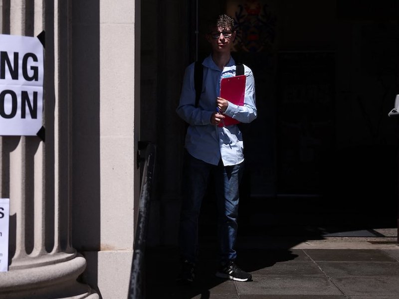 A voter stands at the entrance to a polling station at Clacton Town Hall in Clacton-on-Sea, eastern England, on July 4, 2024 as Britain holds a general election.