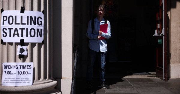 A voter stands at the entrance to a polling station at Clacton Town Hall in Clacton-on-Sea, eastern England, on July 4, 2024 as Britain holds a general election.