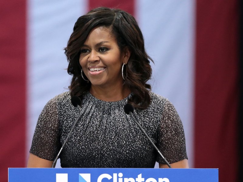 Michelle Obama standing at a podium.