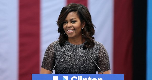 Michelle Obama standing at a podium.