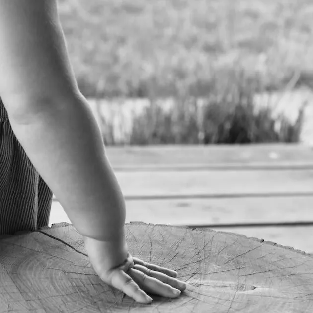 Little summer girl hand blue dress outside