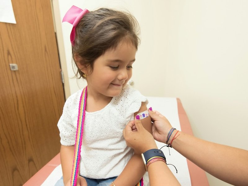 young girl with a plaster on her arm
