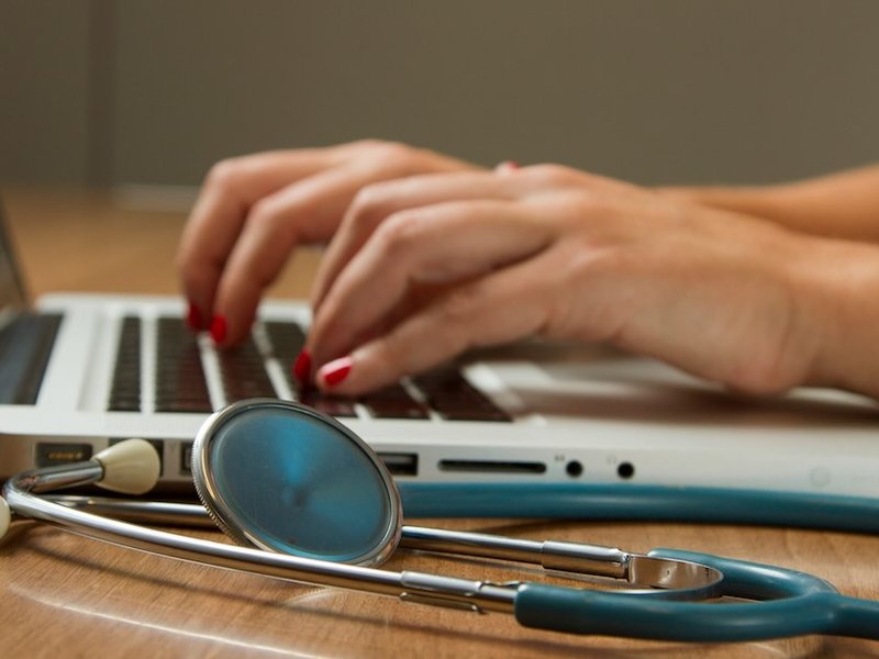 A doctor working on their laptop