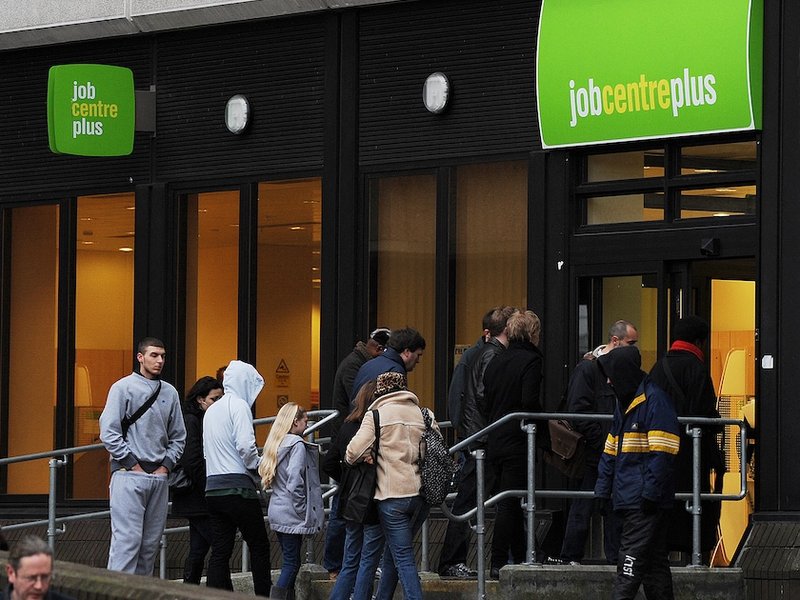 A group of people outside a job centre.