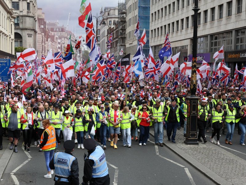 Supporters of British far-right activist Tommy Robinson, real name Stephen Yaxley-Lennon, take part in a march organised by Unite The Kingdom, in central London on May 16, 2026.