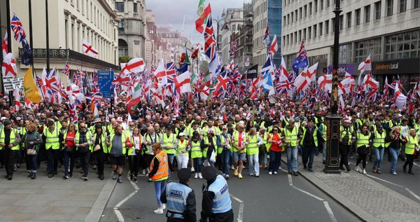 Supporters of British far-right activist Tommy Robinson, real name Stephen Yaxley-Lennon, take part in a march organised by Unite The Kingdom, in central London on May 16, 2026.