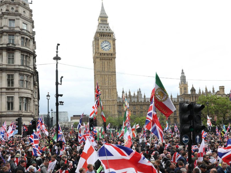 Supporters of British far-right activist Tommy Robinson, real name Stephen Yaxley-Lennon, make their way to Parliament Square after taking part in a march organised by Unite the Kingdom on 16 May.