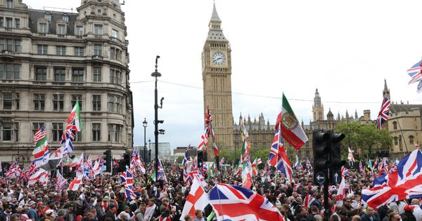 Supporters of British far-right activist Tommy Robinson, real name Stephen Yaxley-Lennon, make their way to Parliament Square after taking part in a march organised by Unite the Kingdom on 16 May.