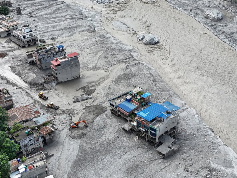 An aerial view shows houses lying deluged in sludge following flash floods at Trishuli in Nepal's Nuwakot district on August 27, 2026.