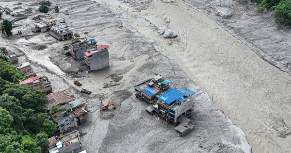 An aerial view shows houses lying deluged in sludge following flash floods at Trishuli in Nepal's Nuwakot district on August 27, 2026.