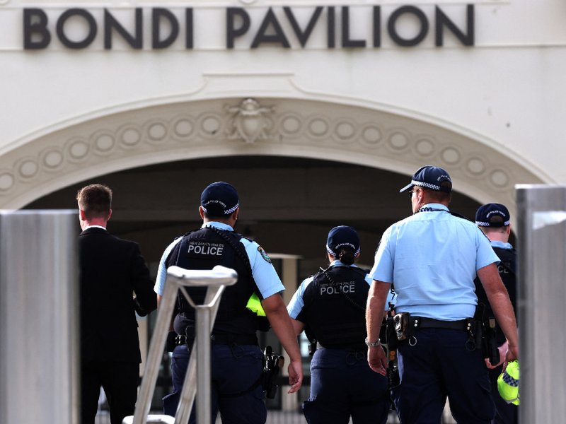 A photo of police inspecting the scene of a shooting at Bondi Beach in Sydney.