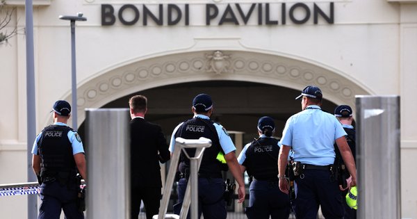 A photo of police inspecting the scene of a shooting at Bondi Beach in Sydney.