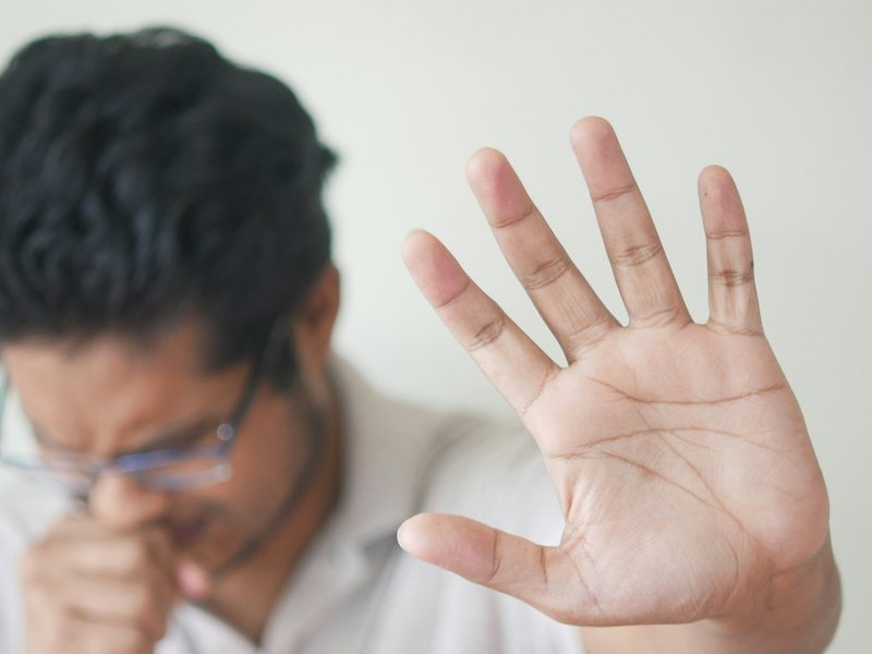 An image of a person coughing.