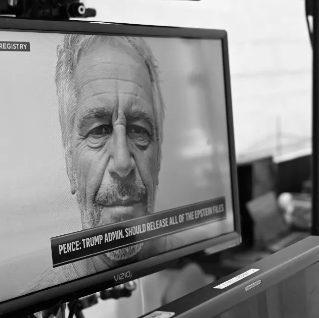 A mugshot of Jeffrey Epstein seen on a television in Washington DC in July 2025.