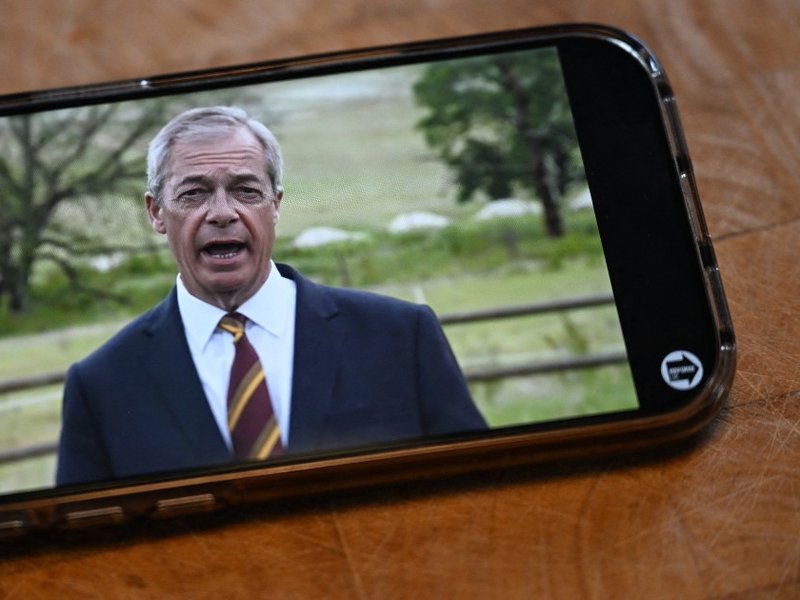 A phone showing a video of Nigel Farage speaking