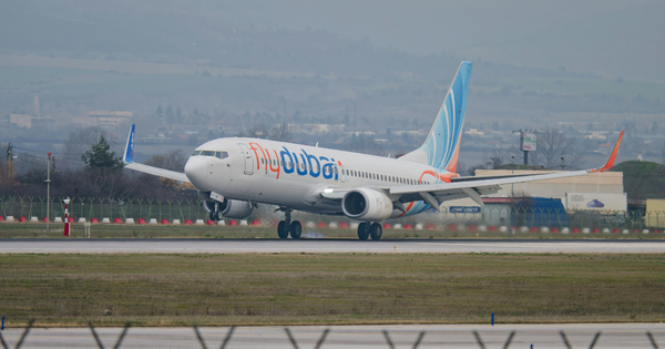 A Flydubai plane landing on a runway.