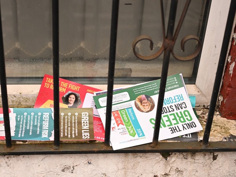 Campaign flyers from various parties on the doorstep of a house in Gorton and Denton