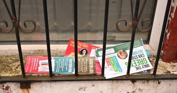 Campaign flyers from various parties on the doorstep of a house in Gorton and Denton