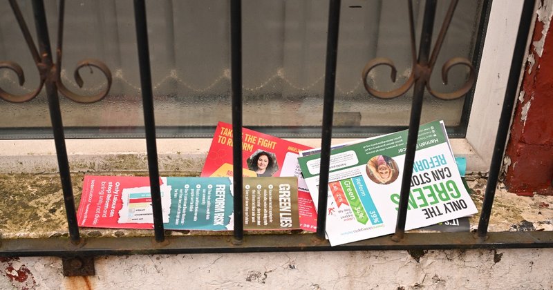 Campaign flyers from various parties on the doorstep of a house in Gorton and Denton