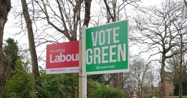 Signs for the Labour Party and the Green Party in Gorton and Denton