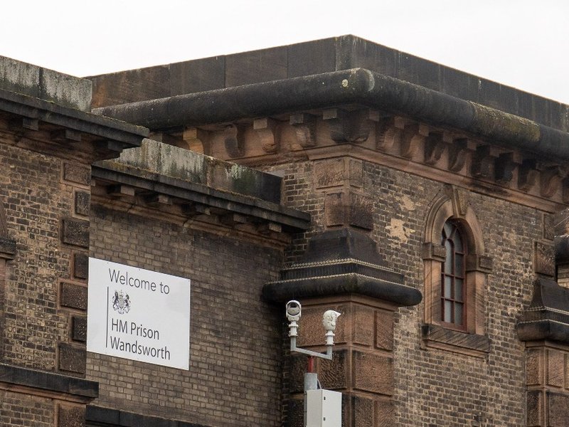 A sign on a building reading “Welcome to HM Prison Wandsworth”