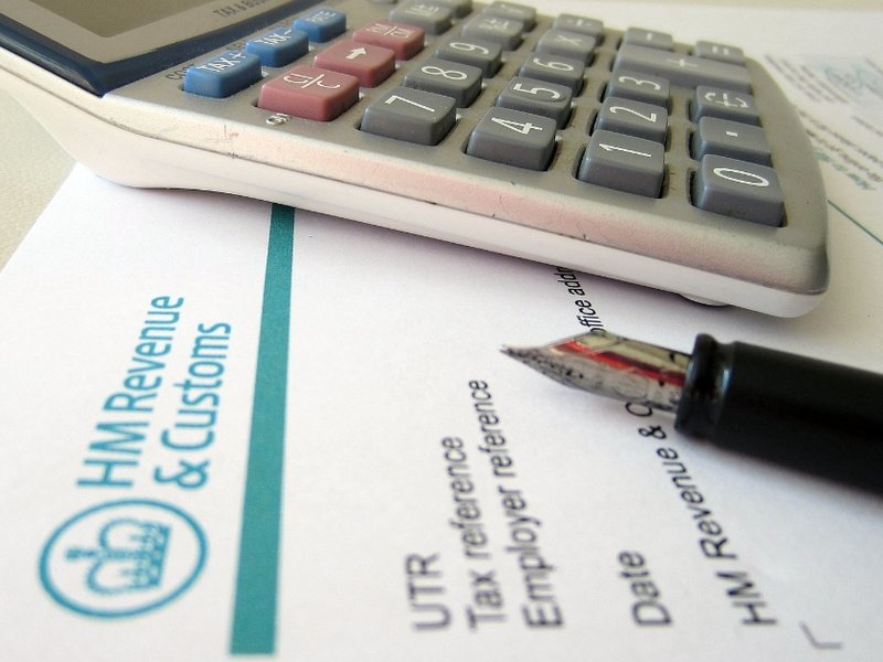 A photo of a calculator next to a letter from HM Revenue and Customs.