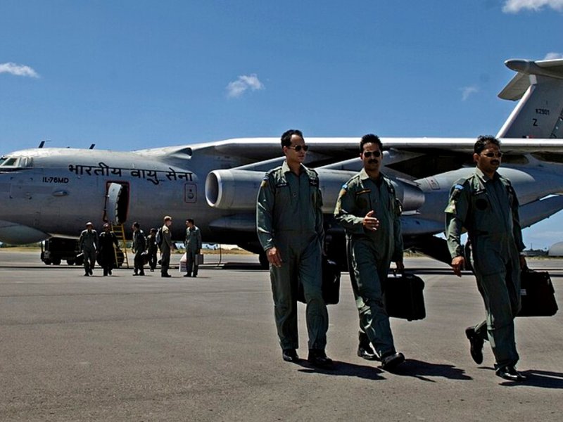 Indian Air Force pilots walk away from their aircraft.
