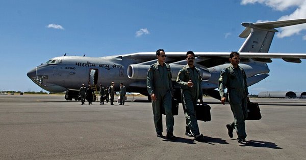 Indian Air Force pilots walk away from their aircraft.