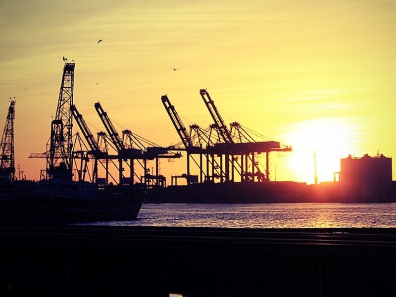 Sun shining behind cranes at Karachi Port, Pakistan