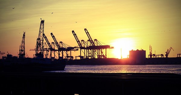 Sun shining behind cranes at Karachi Port, Pakistan