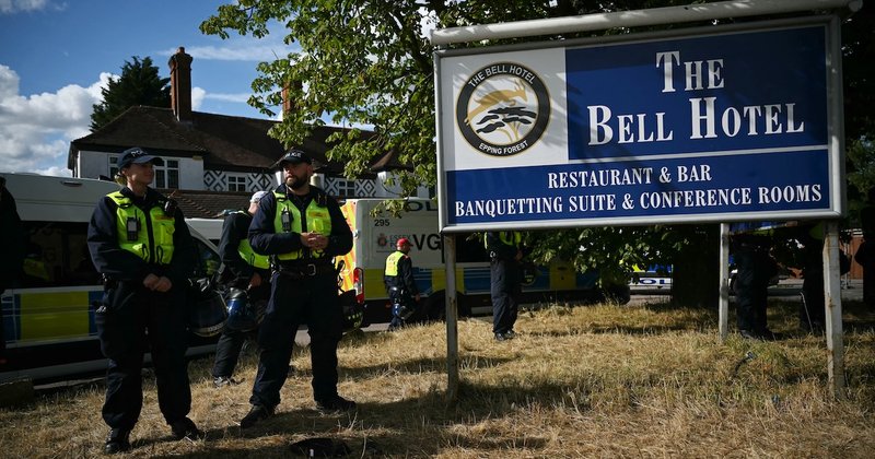 A photo of The Bell Hotel with police stood outside