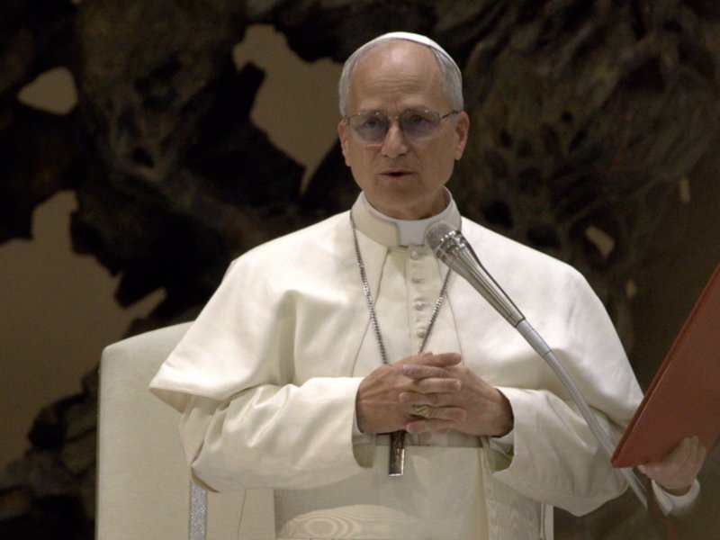 Pope Leo XIV speaking into a microphone