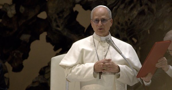 Pope Leo XIV speaking into a microphone