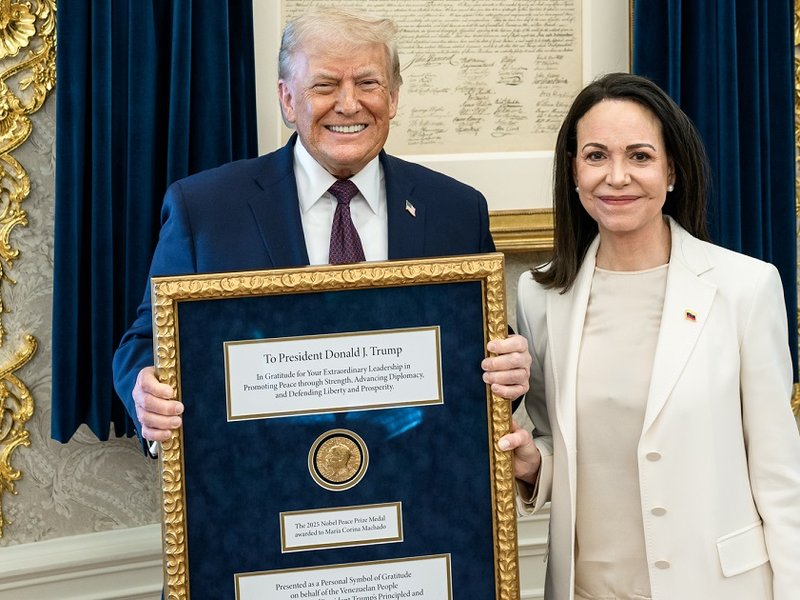 US President Donald Trump being presented with the Nobel Peace Prize awarded to Venezuelan opposition leader Maria Corina Machado.
