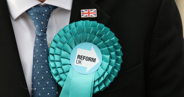 A person wearing a Reform UK rosette
