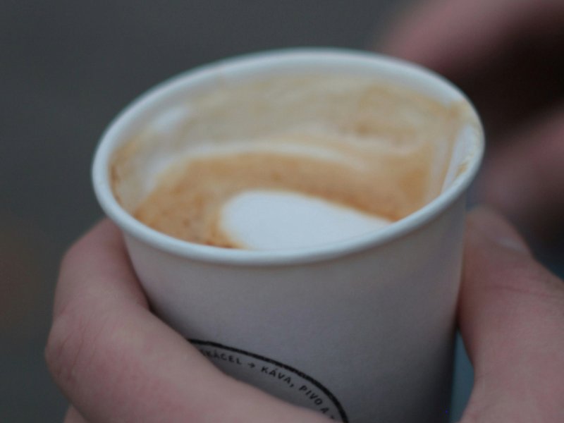 A picture of someone holding a cup of coffee.