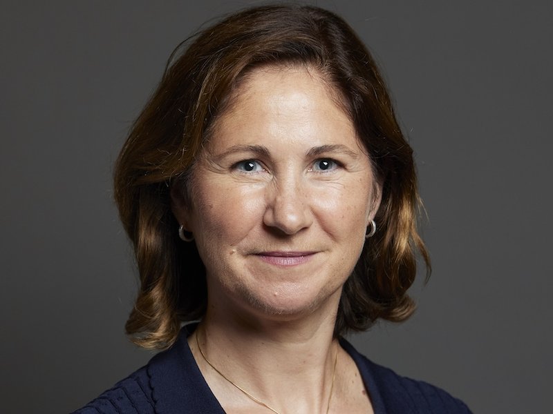 Parliamentary photo of Anna McMorrin, a brown-haired woman wearing a navy dress looking at the camera