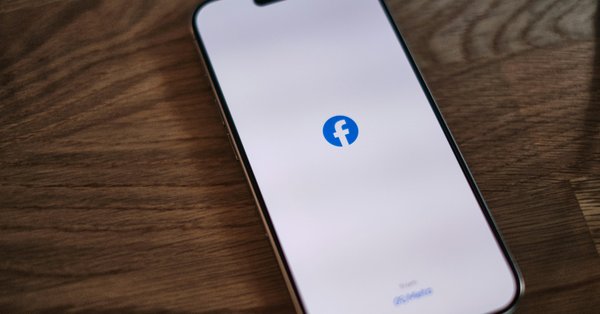 A phone displaying Facebook’s logo