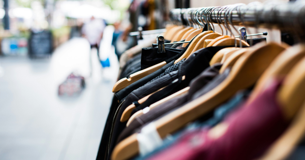 Close up of hangers on a clothes rack.